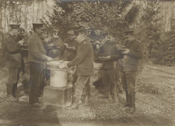 Cooks handing out soup to soldiers on a cold day at the front. 