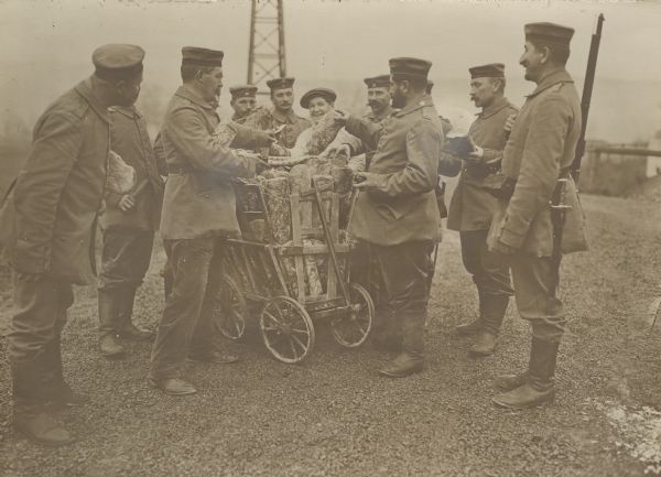 A cook is distributing bread to hungry soldiers and officers on the front. 