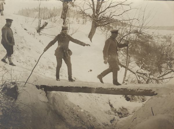 German troops crossing a log bridge. 