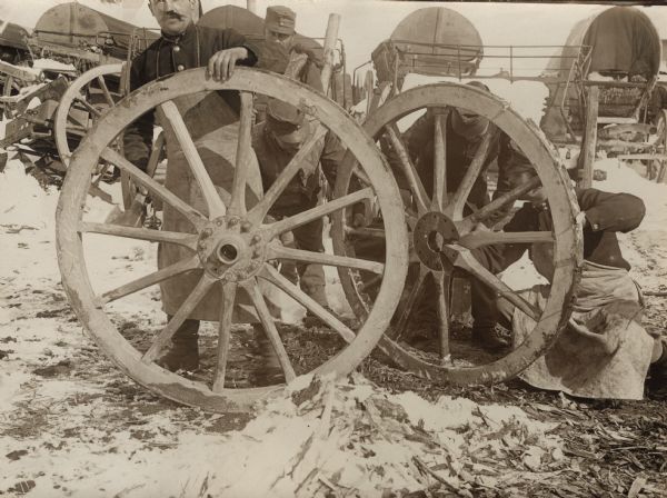 Repairing wagon wheels in a "cannon hospital" behind the front. 