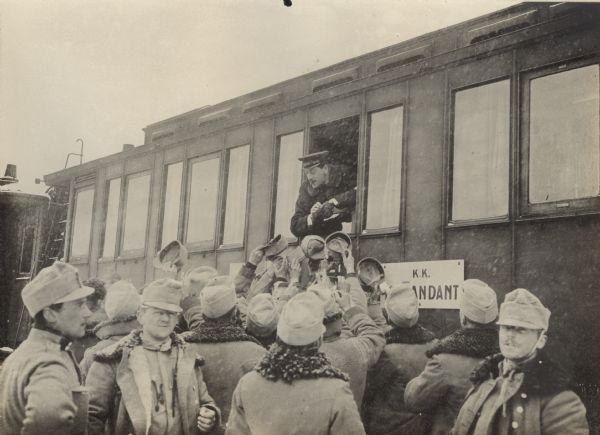 Austrian soldiers gathering around a hospital train that is also carrying gifts from home.