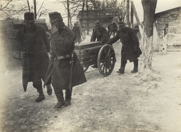 Soldiers hauling ammunition with a small wagon in the Carpathians.