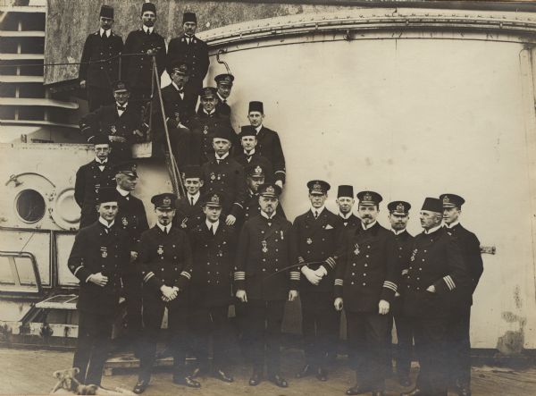 Officers of the <i>Sultan Javus Selim</i> posing for a group portrait on the deck of the ship. 