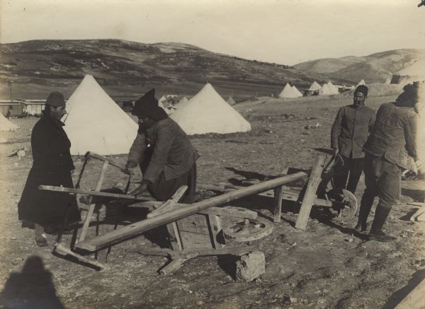 Turkish soldiers building tent frames in the desert.