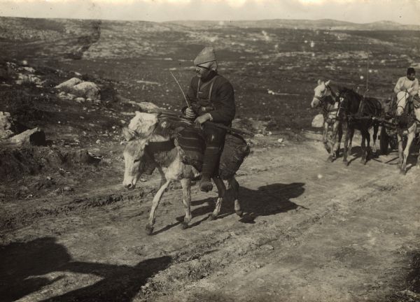 Turkish soldier riding a donkey on the march through Syria.