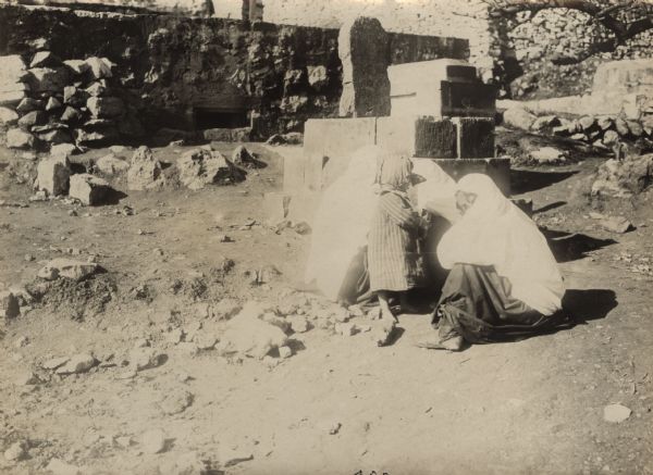 Women in Hebron mourning at the grave of a fallen soldier.