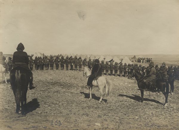 Ali Fuat (Cebesoy) Bey, commander of the 25th Infantry Division, giving an address to the troops in Beersheba about to depart for the Suez Canal. The Hodscha (hodja), on horseback in the middle, is preaching to the troops on the need for strict adherence to the principles of holy war.