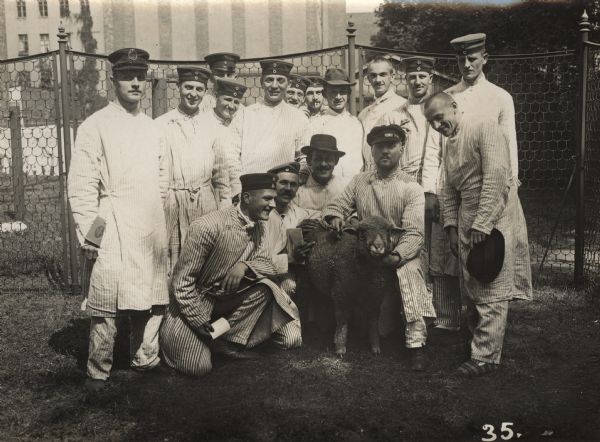 The first wounded soldiers in Berlin. Soldiers are posing outdoors with a "hospital sheep."