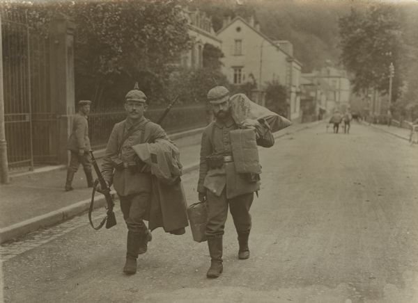 Our Bavarians in the Vosges. Two soldiers with equipment and luggage.
