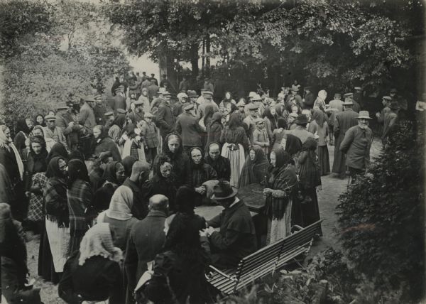 Landrat (local official) distributing gutscheine (food coupons) to the poor.
