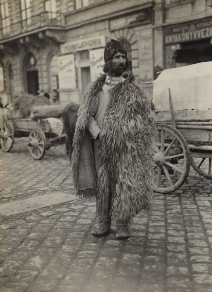 Native of Bukowina posing for a photogarph on city street.