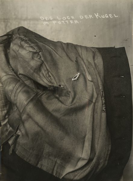 View of a German uniform overcoat with bullet holes.
