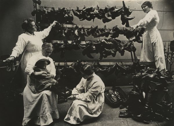 National Women's Service. The indigent and refugees from East Prussia receiving free shoes, clothing, and underwear.