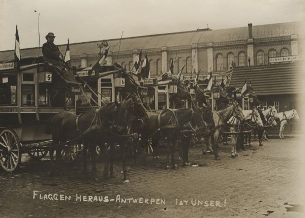 Horse-drawn trams in Berlin, bedecked with German flags, celebrating the capture of the City of Antwerp in October 1914.