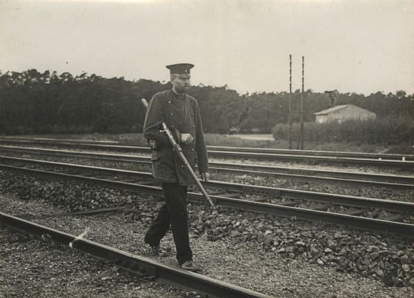 Railway track guard. On guard with a rifle.