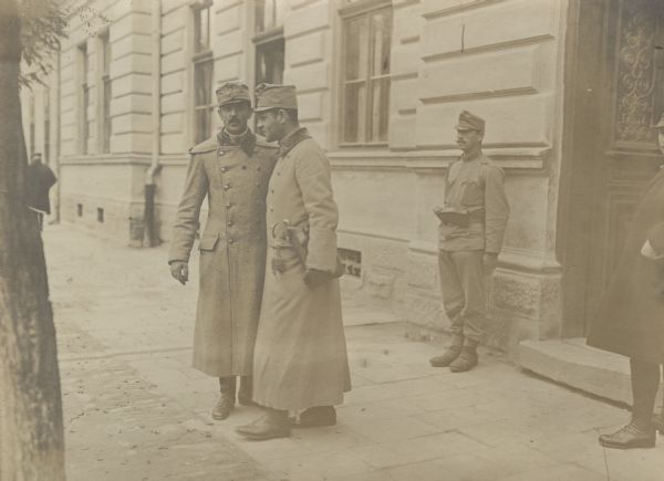 Staff officers standing outside military headquarters.