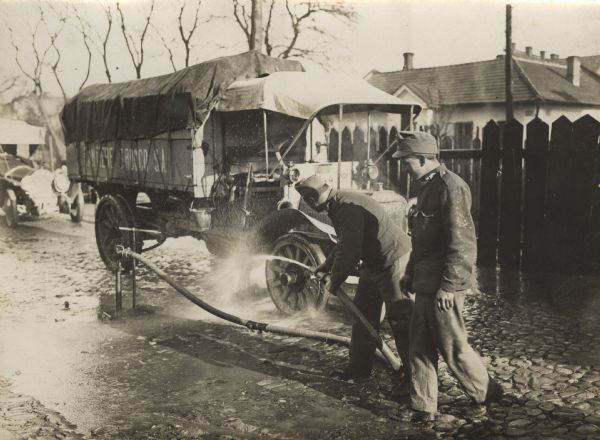 Austrian soldiers washing a supply truck in military headquarters before it leaves for the front.