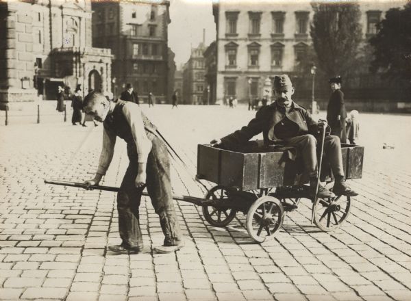 A Viennese errand boy pulling a wounded soldier in a cart to his destination.