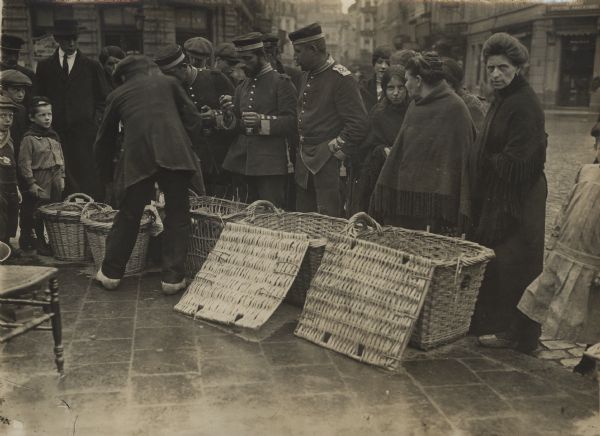 Our naval soldiers buying fruit. German forces occupied Antwerp on October 10th, 1914 after a two week siege.