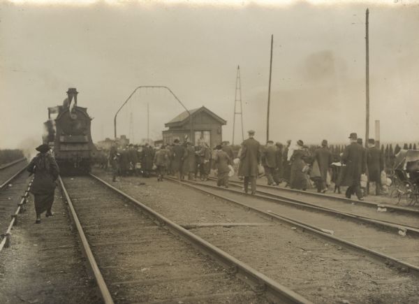 View of the neutral train entering Merxen (Merskem), near Antwerp, bringing refugees from Holland.