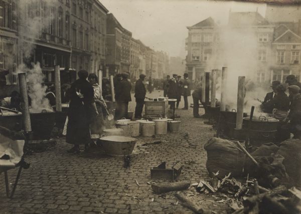 Belgian refugees cooking midday meals in the marketplace of Bergen op Zoom.