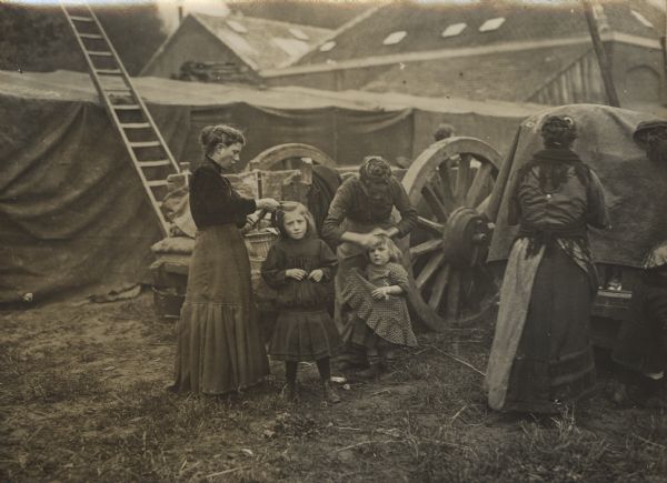 Belgian refugees in Holland. Mothers are combing their children's hair in the morning.