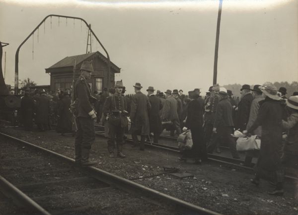Belgian refugees gathering on train tracks on their way to return home.