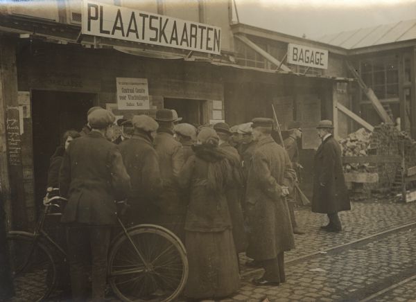 Refugees receiving their railway tickets in Bergen op Zoom for the trip to Merxen. Bergen op Zoom, the first large city on the Dutch side of the border was the main entry point for refugees fleeing from Belgium.