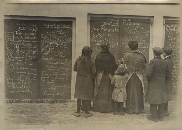 Refugees using every wall space to write messages and addresses in order to inform their relatives of their location.