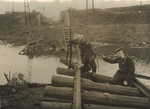 Soldiers repairing a bridge near Merxen, Belgium.