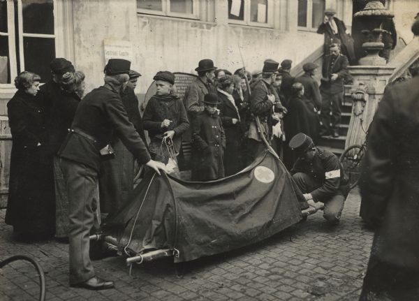 A refugee who had collapsed from exhaustion is being carried away by Dutch soldiers. Bergen op Zoom, the first large city on the Dutch side of the border, was the main entry point for refugees fleeing from Belgium.