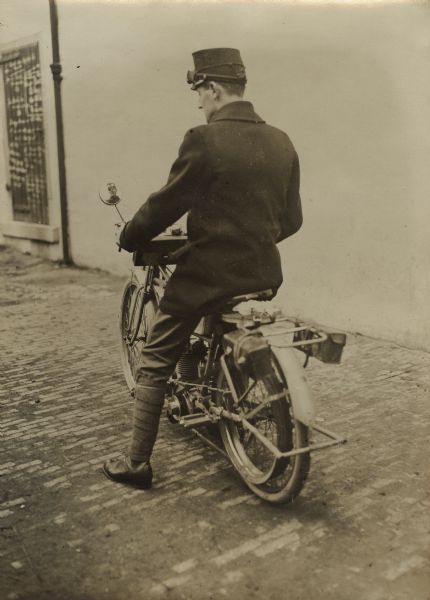 Dutch motorcyclist with a new invention. The rear-view mirror on his handlebars, which has a reflection of the man, allows a clear view of what's behind him.
