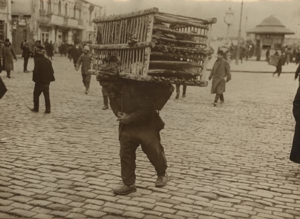 A soldier carrying supplies to the headquarters, preparing to head to the front. 