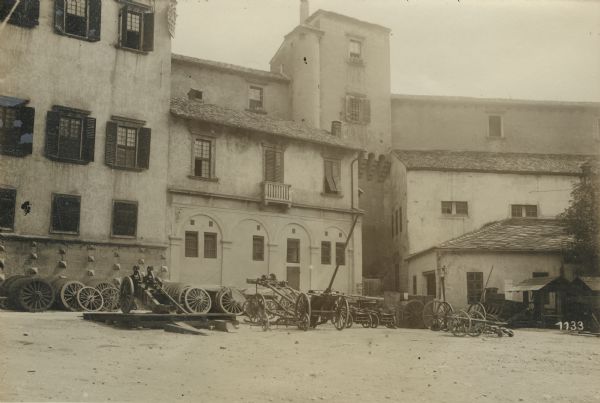 Wheels and limbers are lined up against a building in Trient (Trento).