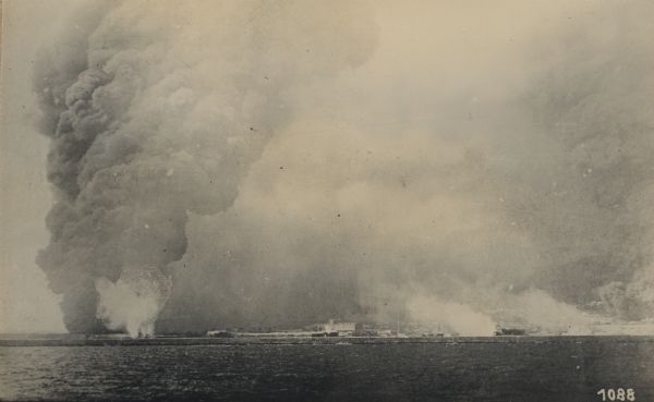 Bombardment of the harbor of Novo Rossijsk (Novorossisk) by the light cruiser "S.M.S. Breslau, now the "Midilli." The white smoke in the center is from an explosion on a steamship. 