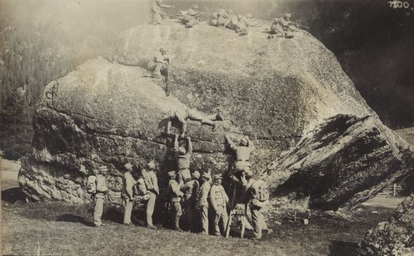 Soldiers of a rifle guild fighting from large boulder. 