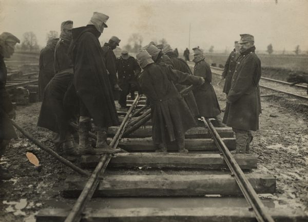 Necessary work in enemy territory. Austrian engineers laying rails for a roadbed to make the transport of provisions easier.