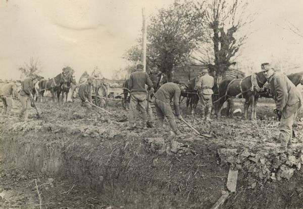 Soldiers attempting to repair badly damaged Serbian roads. 