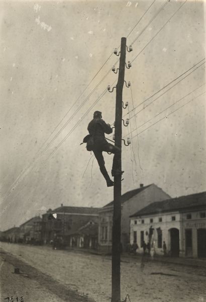 Destroyed telephone lines in Serbia being repaired for use. 