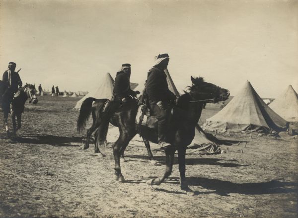Senussi fighters, on horseback, returning from a patrol in the desert. 