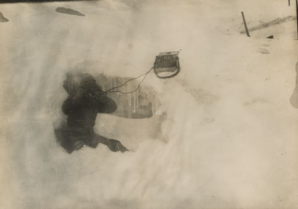 Dutiful artillery forward observer, in a snowstorm in an ice cavern on a glacier, at an elevation of 3600 meters, overlooking Italian territory. 
