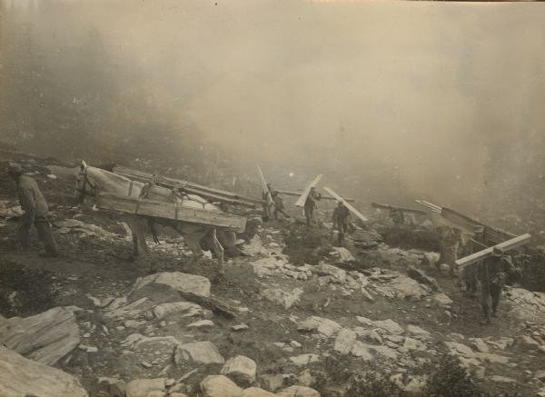 Transporting building lumber to our high altitude fighting positions on the Italian-Tirolian front. 