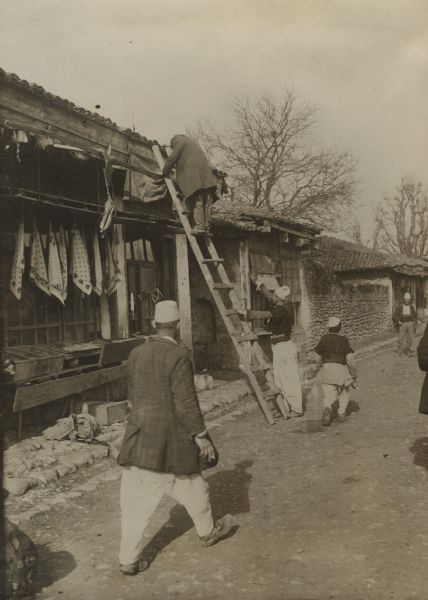 Returning Turkish merchant reopening his store in Skutari, Albania.
