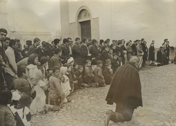 The celebration of the first mass for our troops in the cathedral in the Catholic section of Skutari. The crowd is kneeling while waiting to enter the church for the mass, Montenegro and Albania. 