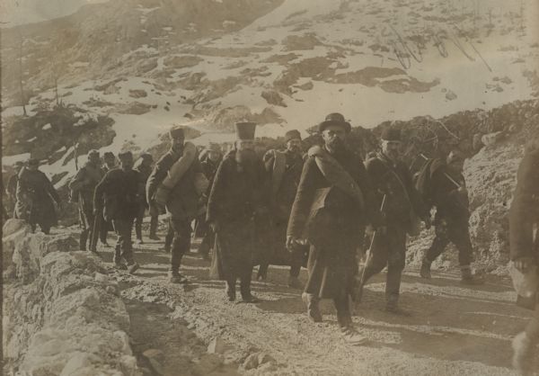 Disarmed Serbian and Montenegran soldiers, as well as civilian refugees, crossing the Black Mountains from Albania on their way home. 