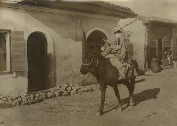 Muslim woman riding sidesaddle on a horse in Skutari, Albania.