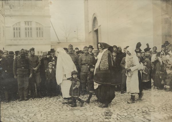 The celebration of the first mass for our troops in the cathedral in the Catholic section of Skutari. Albanian Catholics are leaving the church after mass, Montenegro and Albania.