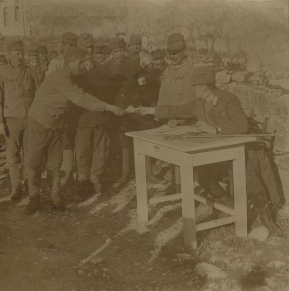 Austrian soldiers in Albania being paid. 