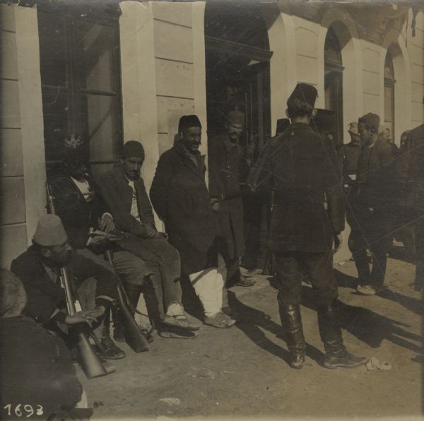 Albanian men, standing in front of the Town Hall in Skutari, Albania seeking employment with Austro-Hungarian forces.