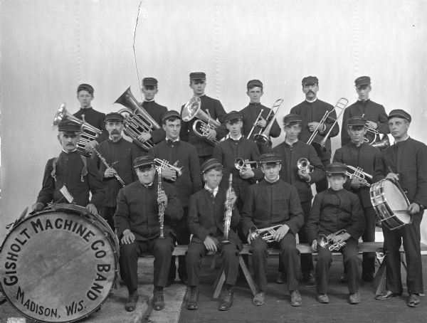 Group portrait of the Gisholt Machine Company band. Seventeen musicians are shown in three rows. 